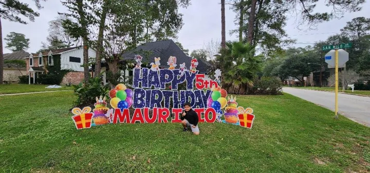 Custom happy birthday yard greeting installed in a front yard